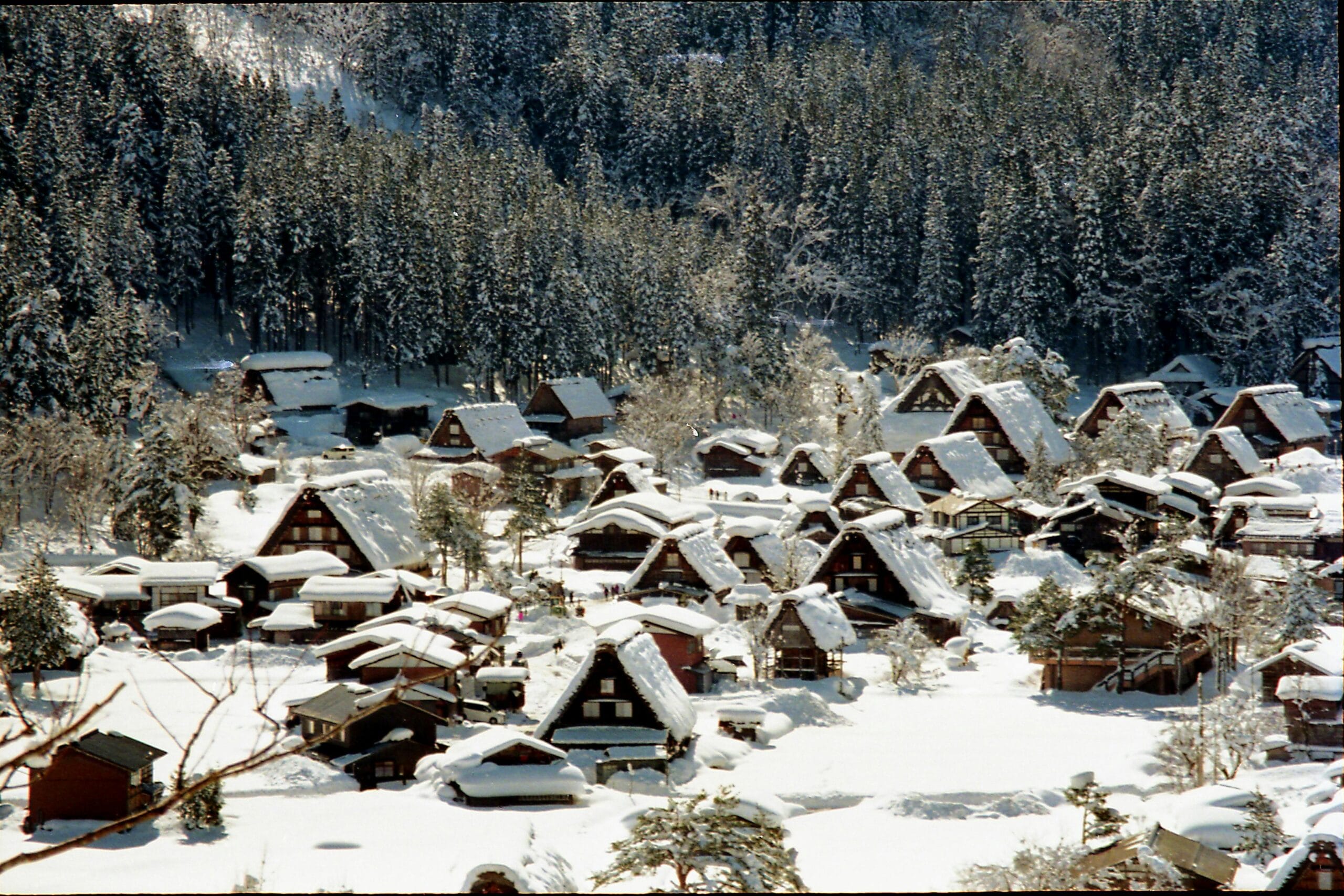 A scenic view of Shirakawa-go village in Japan, blanketed in winter snow.