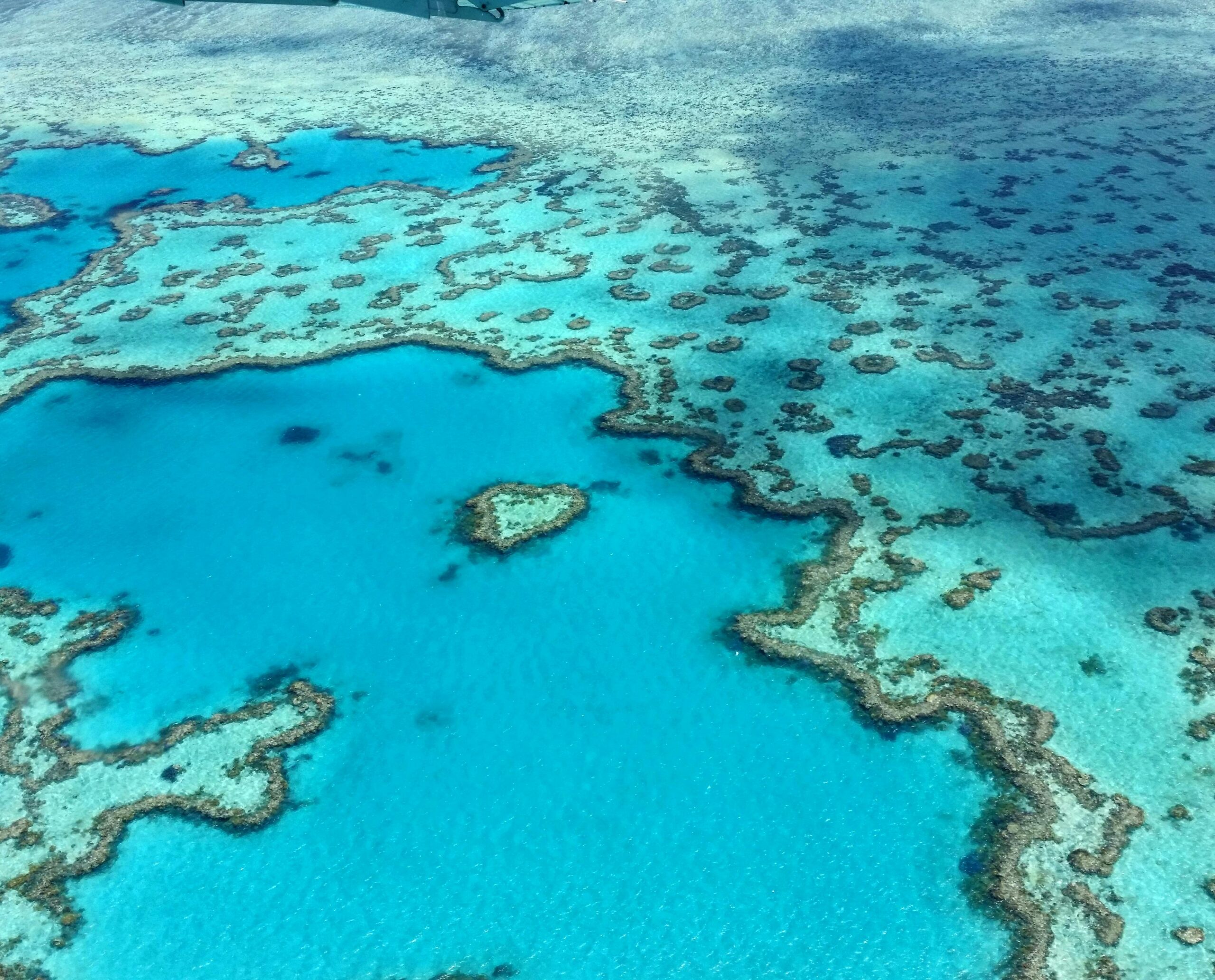 Stunning aerial photograph of the heart-shaped Great Barrier Reef in the Whitsundays, Australia.