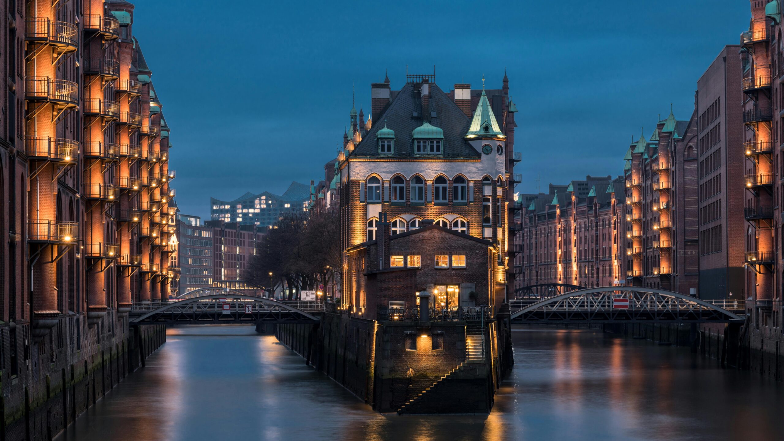 Top 12 Undiscovered River Cruises to Unveil Hidden Worlds Illuminated Speicherstadt district in Hamburg, Germany, featuring historic warehouses and canals at dusk.