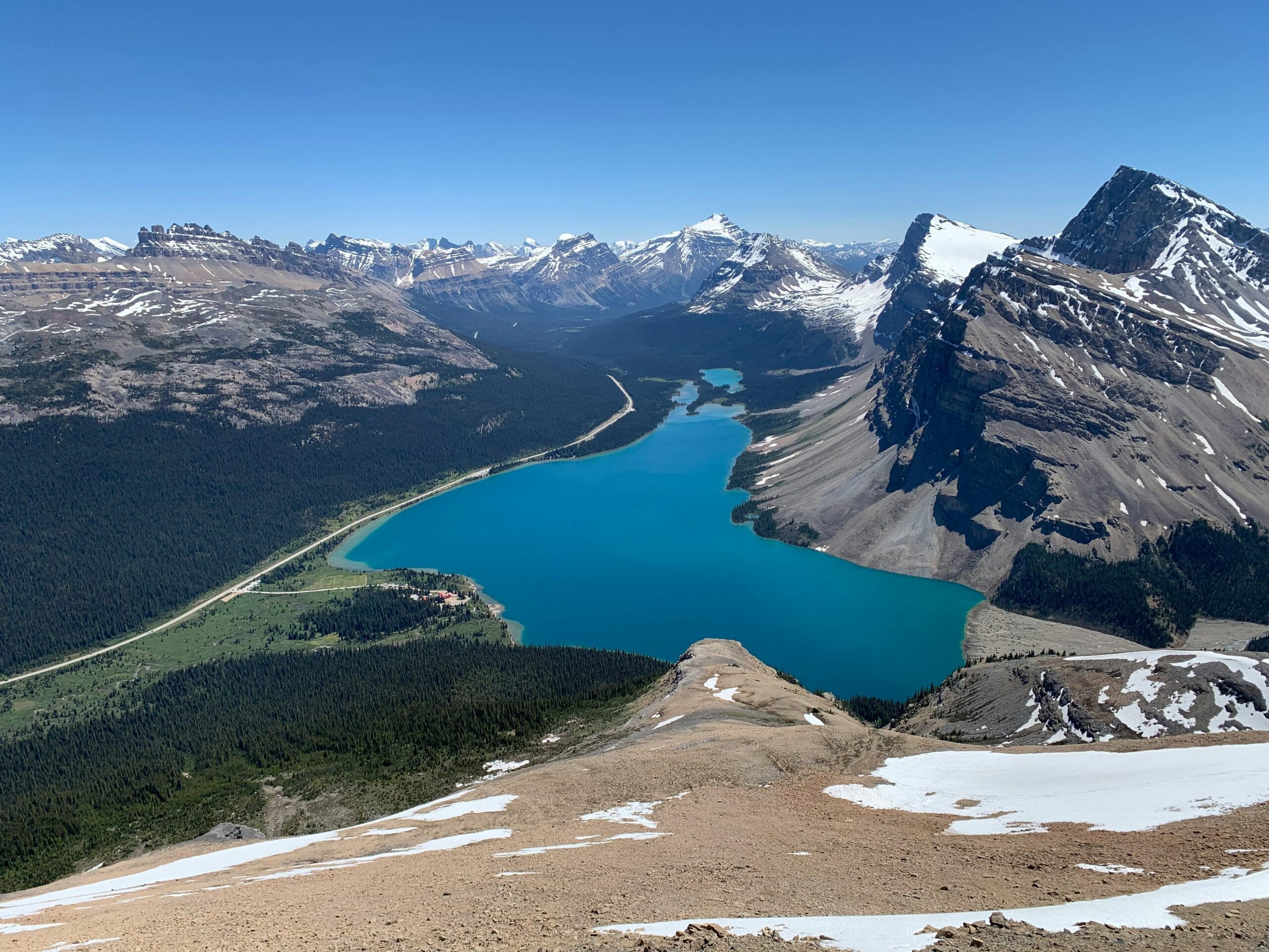 A breathtaking aerial view of Bow Lake and the snow-capped Canadian Rockies in Alberta, Canada.