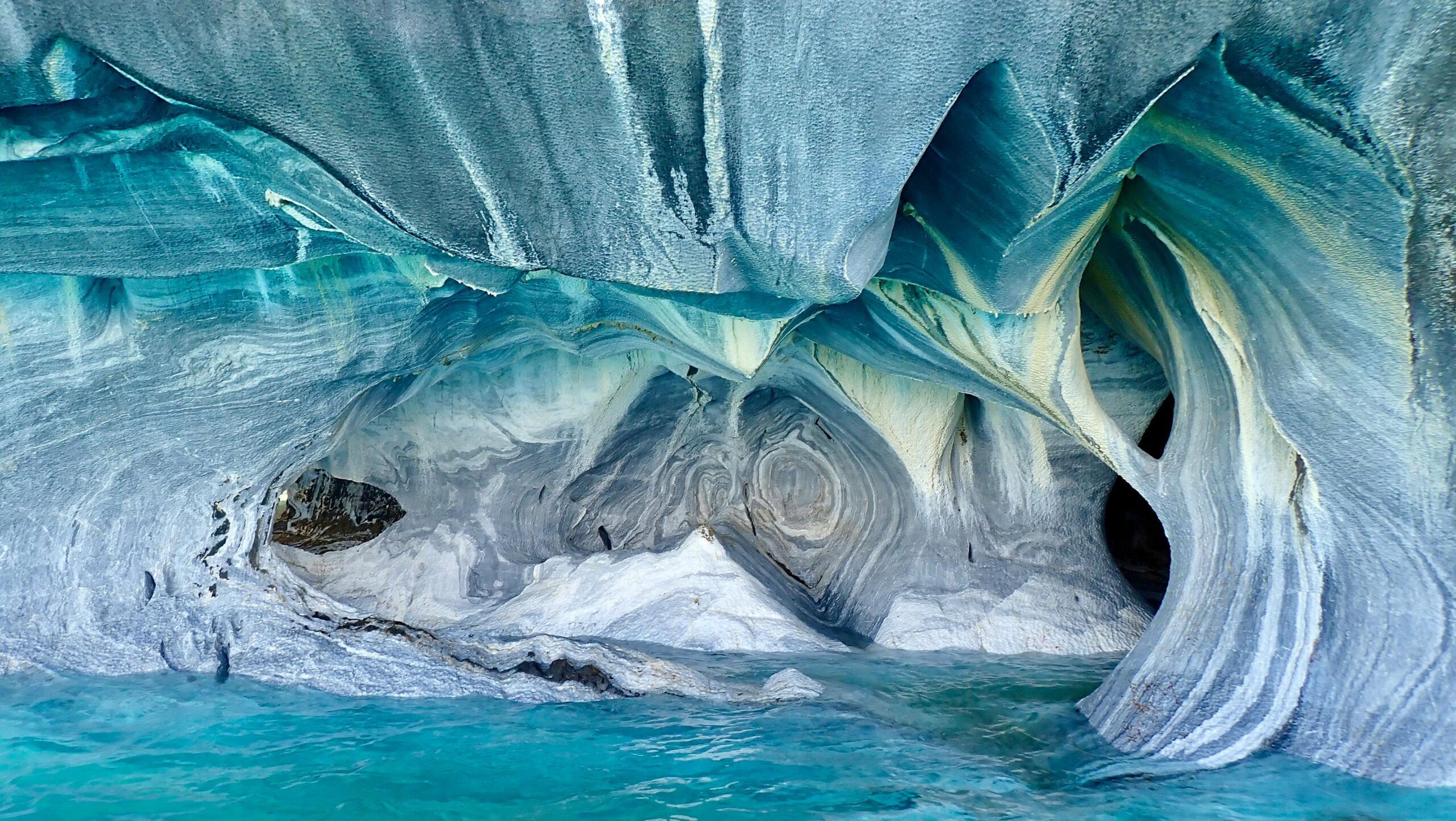 Top 9 Undiscovered Wilderness Retreats You Need to Explore Now Beautiful marble caves formations in Patagonia with turquoise waters below, Chile.