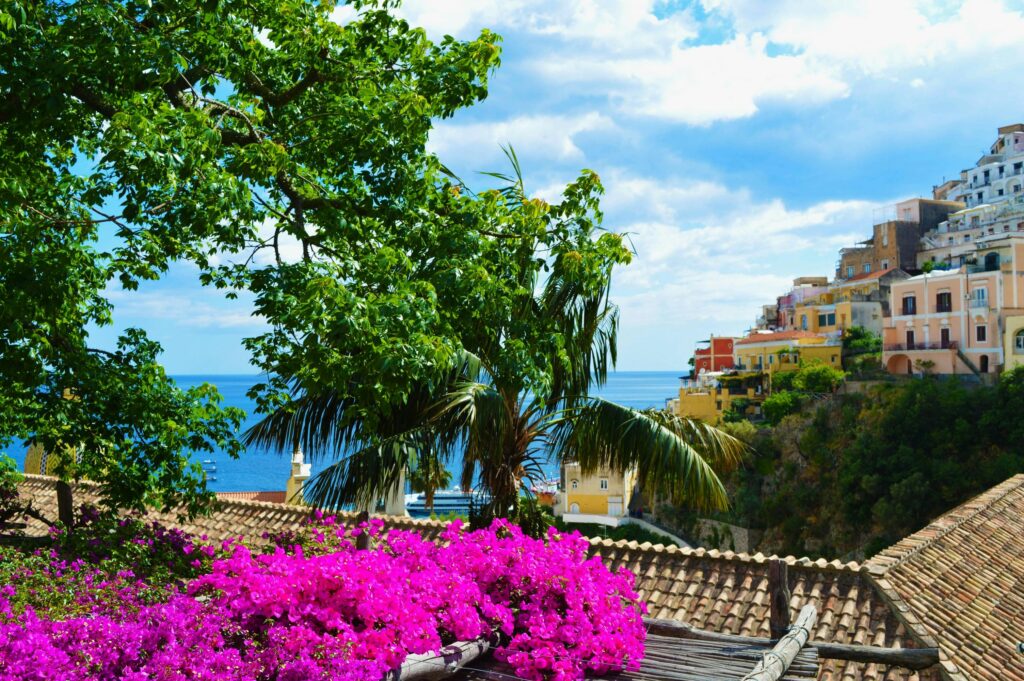 Top 10 Destinations in Italy Colorful coastal village with lush flora and sea view, ideal for travel and architecture enthusiasts.